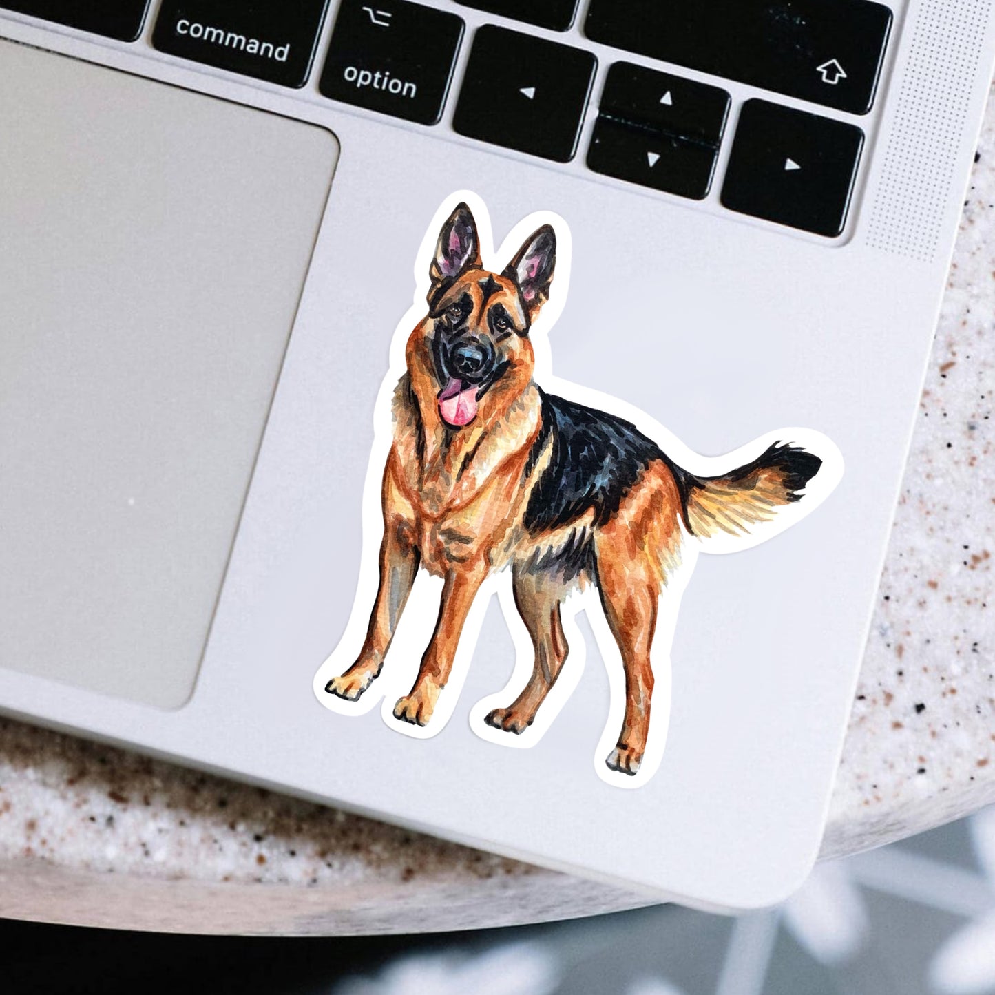 Laptop with a German Shepherd sticker on the palm rest area