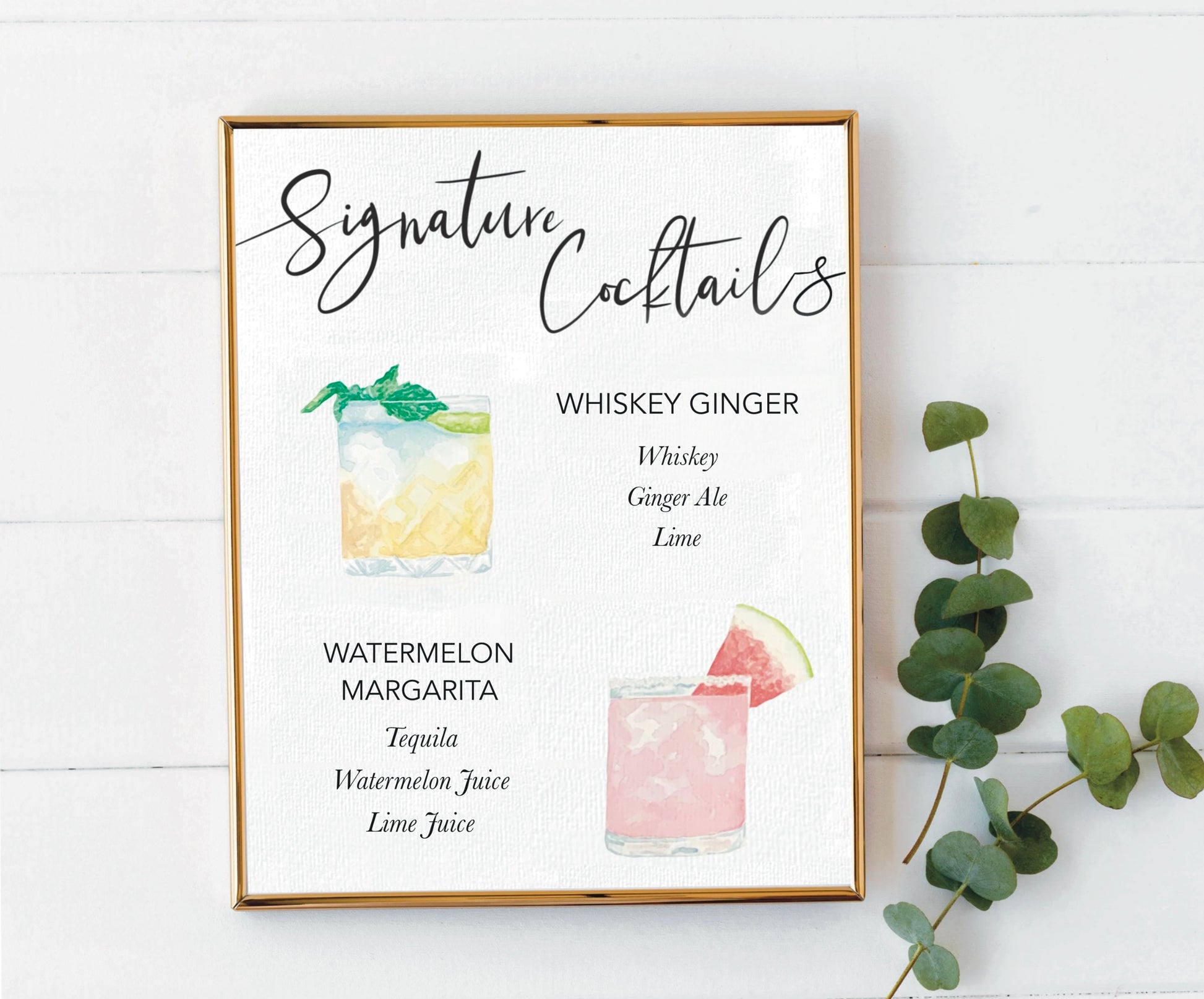 signature cocktail sign in a gold frame with greenery