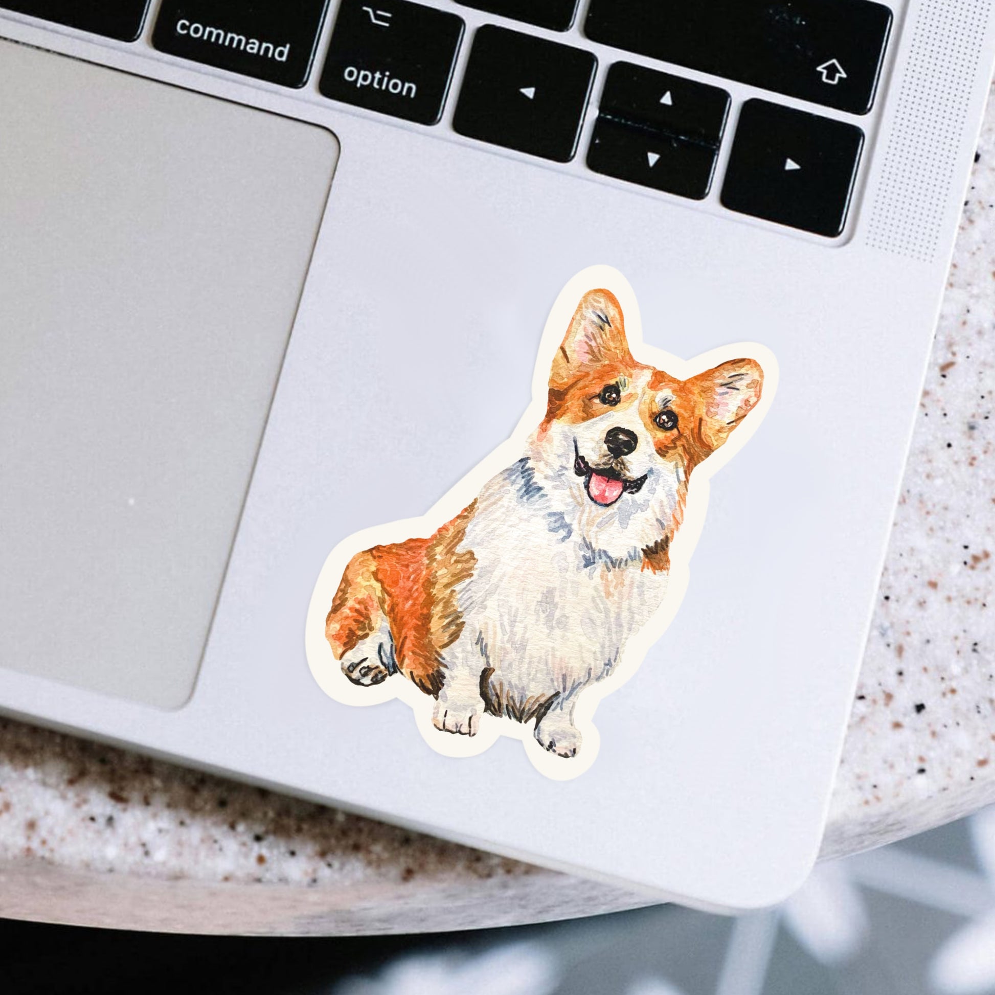 Laptop with a corgi sticker on the palm rest area