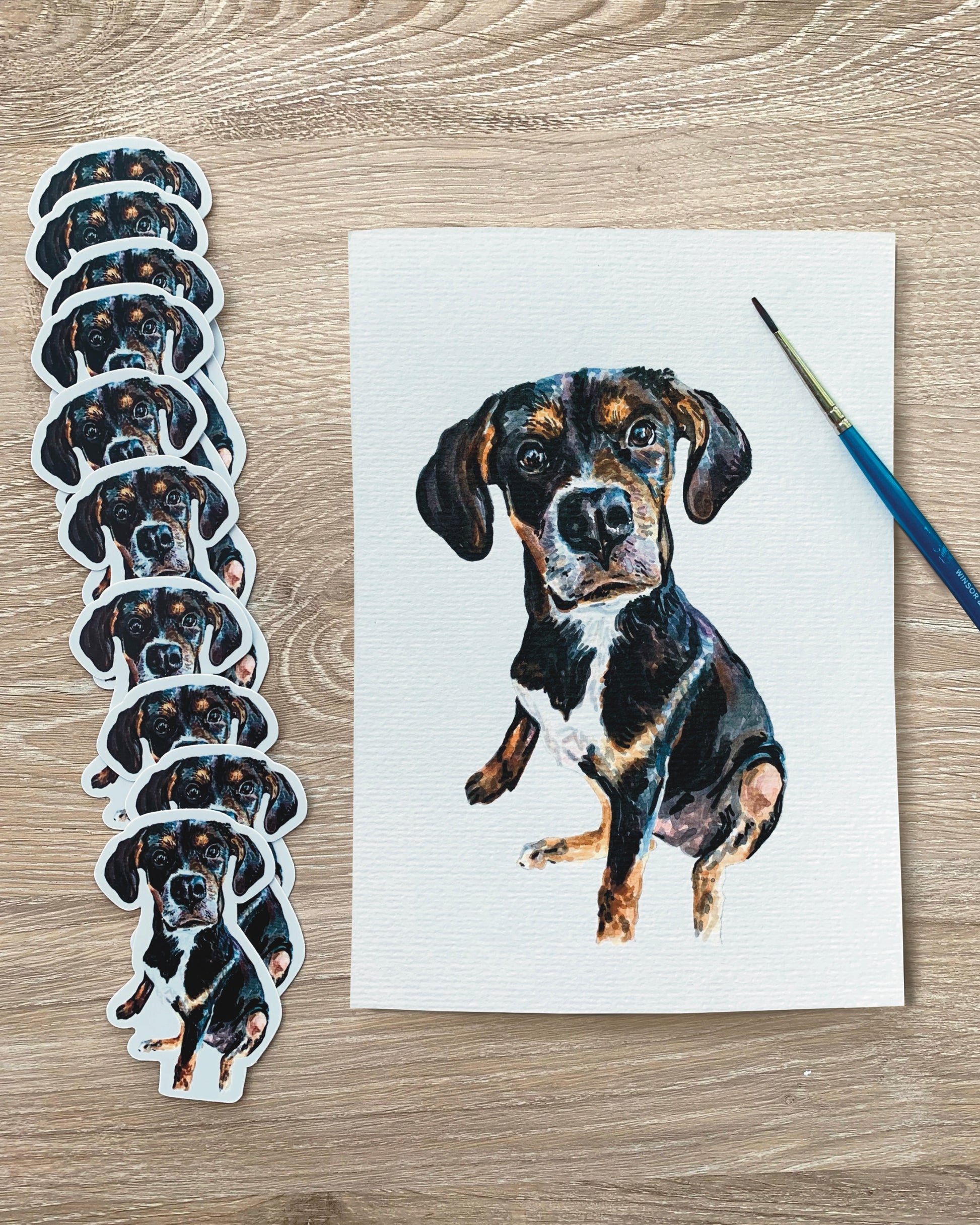 A set of  vinyl stickers featuring a hand-painted portrait of a dog, with the main sticker in focus and others in the background.