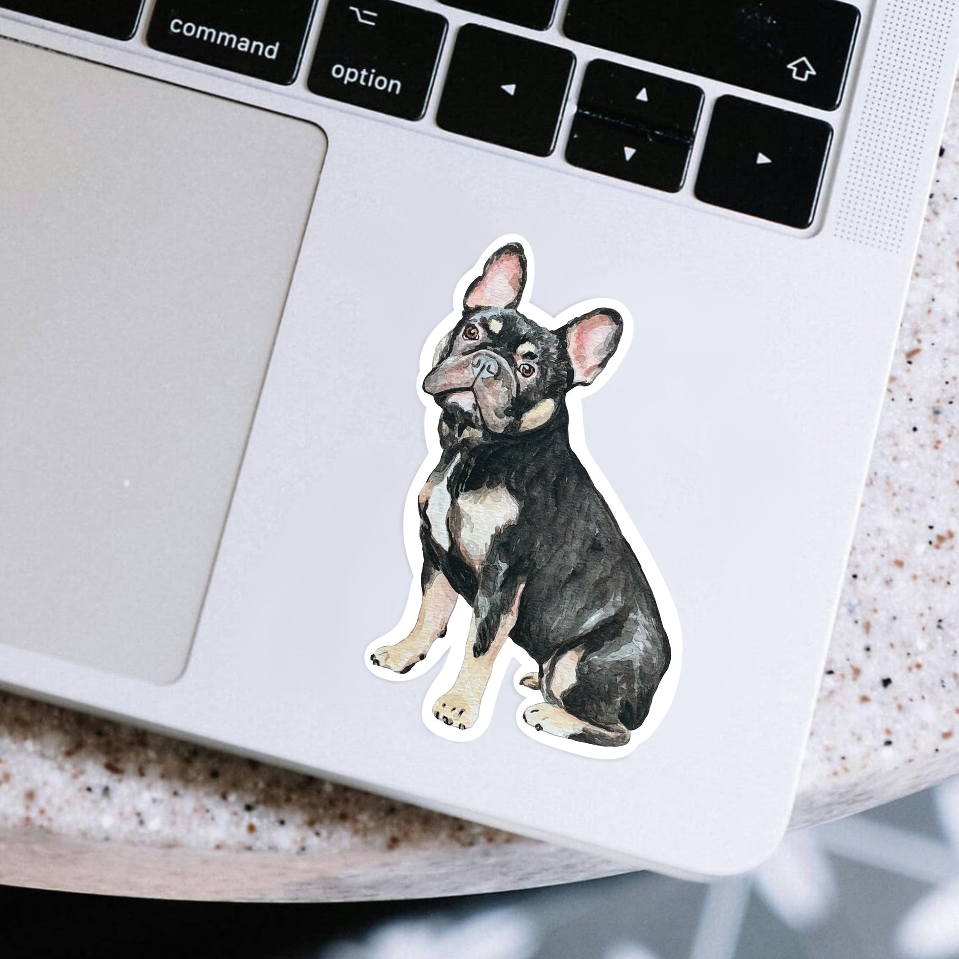 Laptop with a sticker of a frenchie dog on the palm rest area