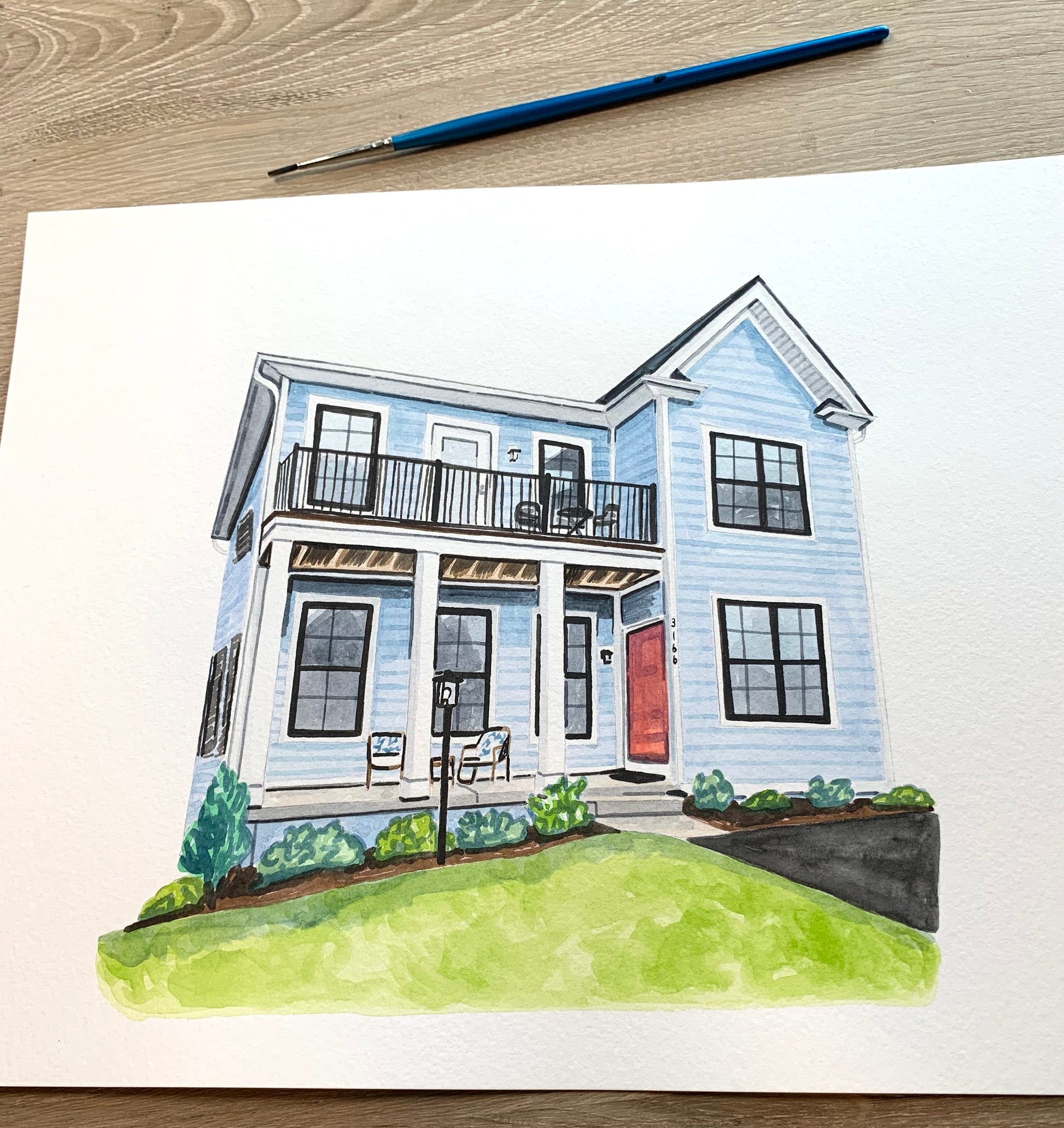 Colorful  watercolor illustration of a two-story house with a porch on a white background, with a paintbrush above.