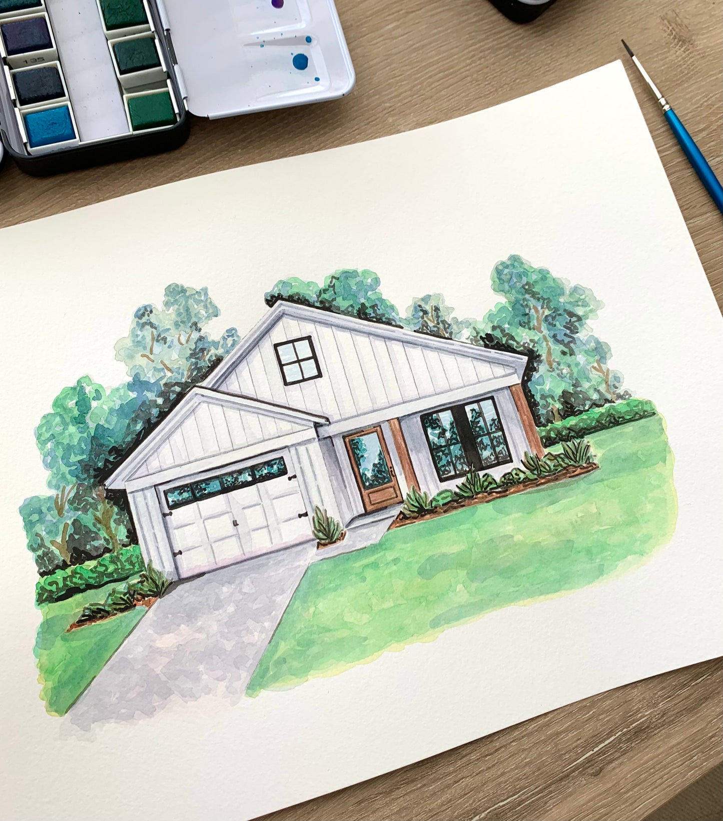 watercolor portrait of a house with landscaping