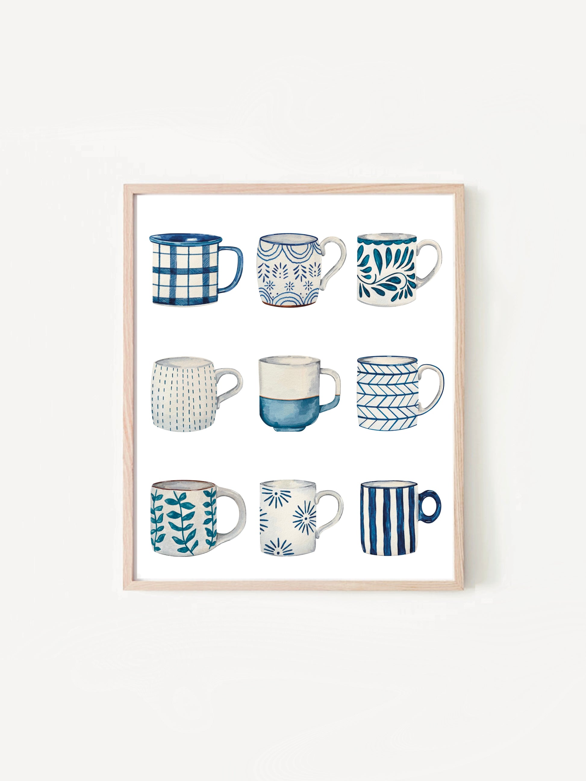 Framed artwork of various blue and white mugs on a white background