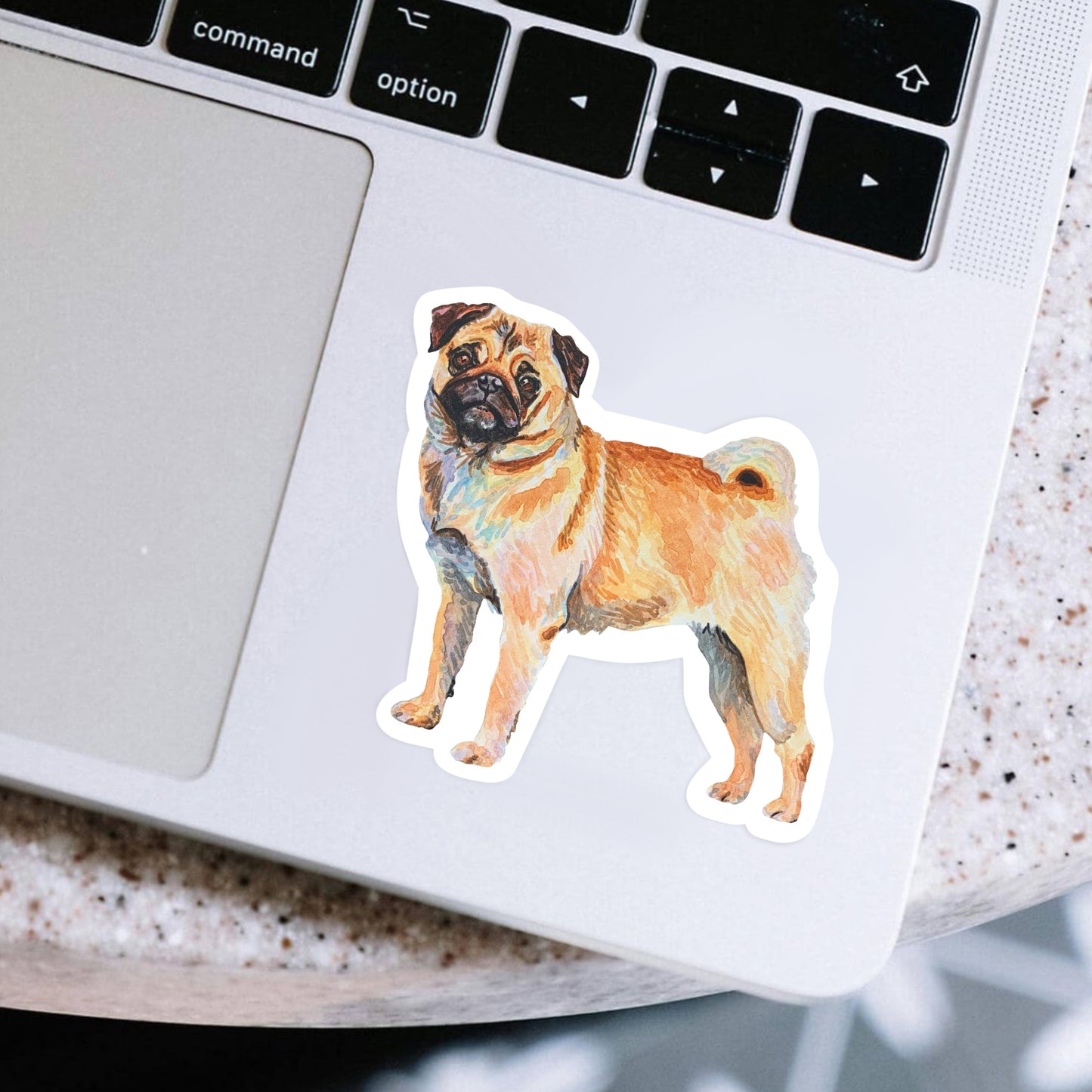 Laptop with a pug sticker on the palm rest area